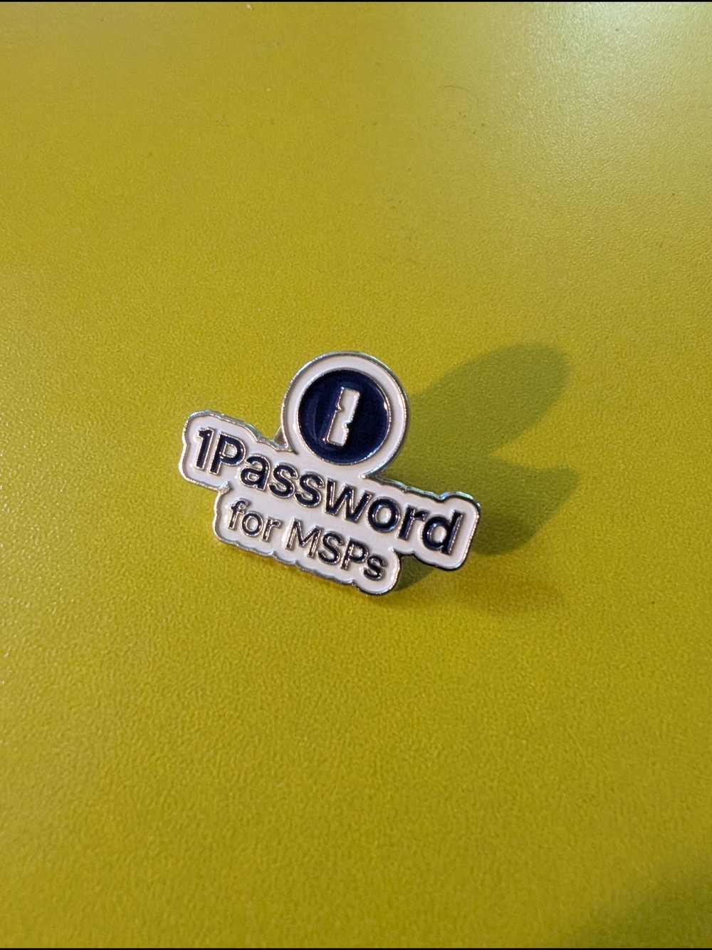 1Password for MSPs Enamel Pin — Silver and Navy